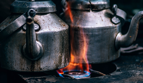 a pair of kettles on a fire